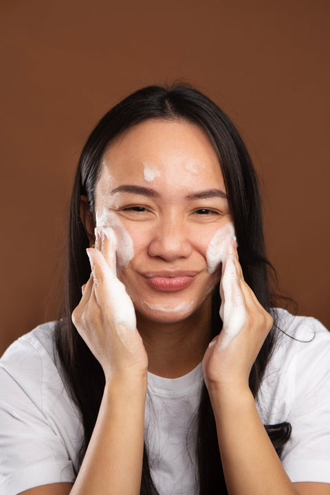 model massaging gentle foaming cleanser onto face