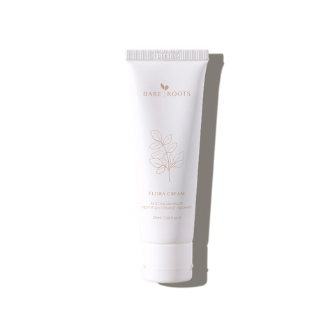 Flora Cream tube standing upright on a light neutral background