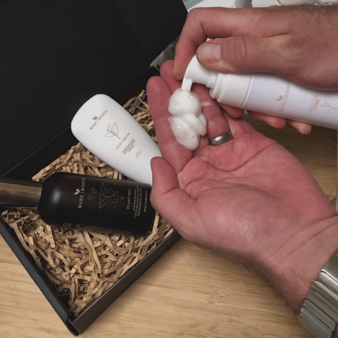Man dispensing Bare Roots Gentle Foaming Cleanser into his hands as part of his skincare routine.