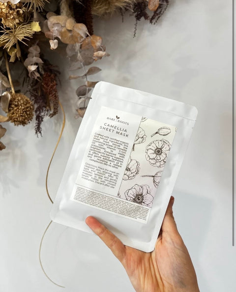 Woman holding Bare Roots Camellia Sheet Mask