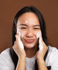 model massaging gentle foaming cleanser onto face