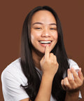 Model applying bare lips with finger