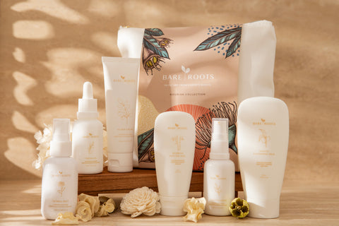 Collection of skincare products with 'Bare Roots' packaging on a wooden surface.