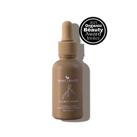 Clear Clarity Serum bottle with white and gold label on a white background