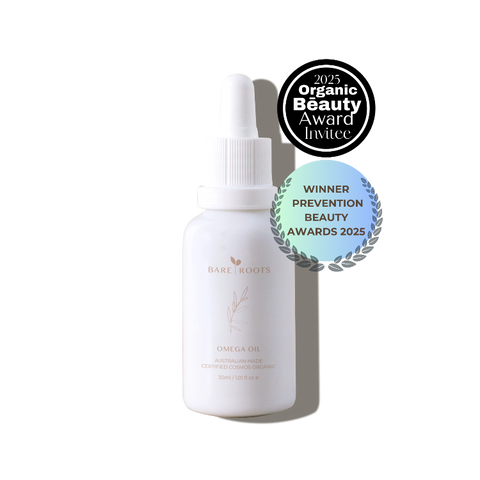 A bottle of Bare Roots Omega Oil placed on soft linen background with golden natural light and a nourishing, organic aesthetic.