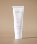 Flora Cream tube standing upright on a beige background