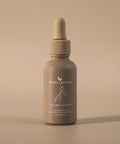 Clarity Serum bottle standing upright on a soft beige backdrop