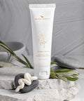 Bare Roots Flora Cream tube on a stone surface with greenery