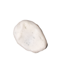 Close-up of Gentle Foaming Cleanser’s creamy foam texture on light surface.