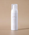 Gentle Foaming Cleanser bottle displayed against a soft beige background.