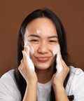 model massaging gentle foaming cleanser onto face