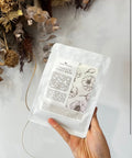 Woman holding Bare Roots Camellia Sheet Mask