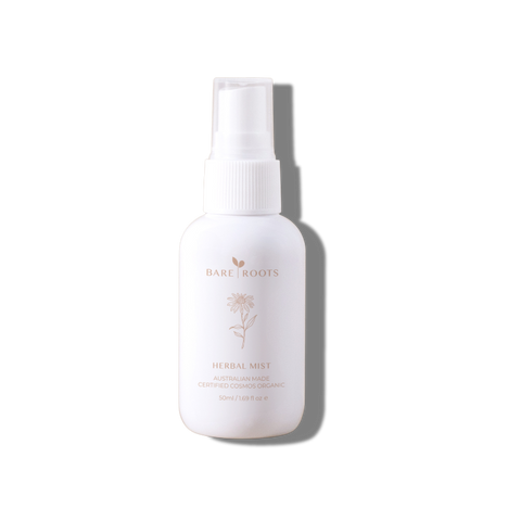 White Herbal Mist spray bottle with gold cap shown on a soft light background