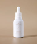 Bare Roots Omega Oil bottle standing upright on a neutral beige background, highlighting its minimalist design.