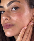 Woman showcasing glowing, refreshed skin after removing Camellia Sheet Mask