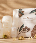 Collection of Bare Roots skincare products on a wooden surface with a natural background.
