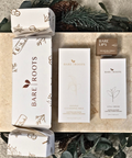 Bare Roots skincare products with decorative greenery on a textured surface