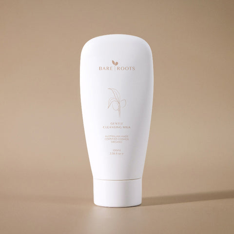 White tube of Bare Roots skincare product on a beige background