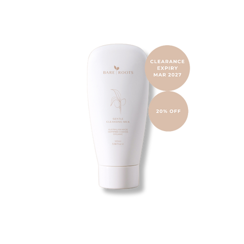 A white Bare Roots Gentle Cleansing Milk tube on a white background, with two beige circular callout badges reading 'CLEARANCE EXPIRY MAR 2027' and '20% OFF'.