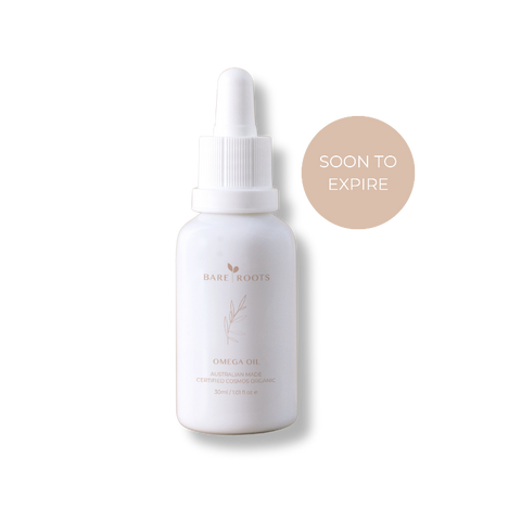 Bottle of 'bare roots' omega oil with a 'soon to expire' label on a white background