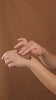 plant peel rubbed into hand against brown background