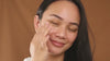 video of model applying marigold cleansing balm to cheek