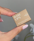 model applying bare lips to lips