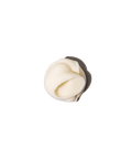 Tube of Vital Cream next to a dollop of creamy product spread on a flat surface.