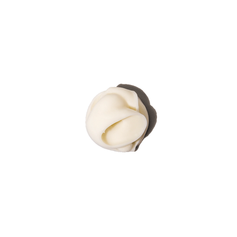 Tube of Vital Cream next to a dollop of creamy product spread on a flat surface.